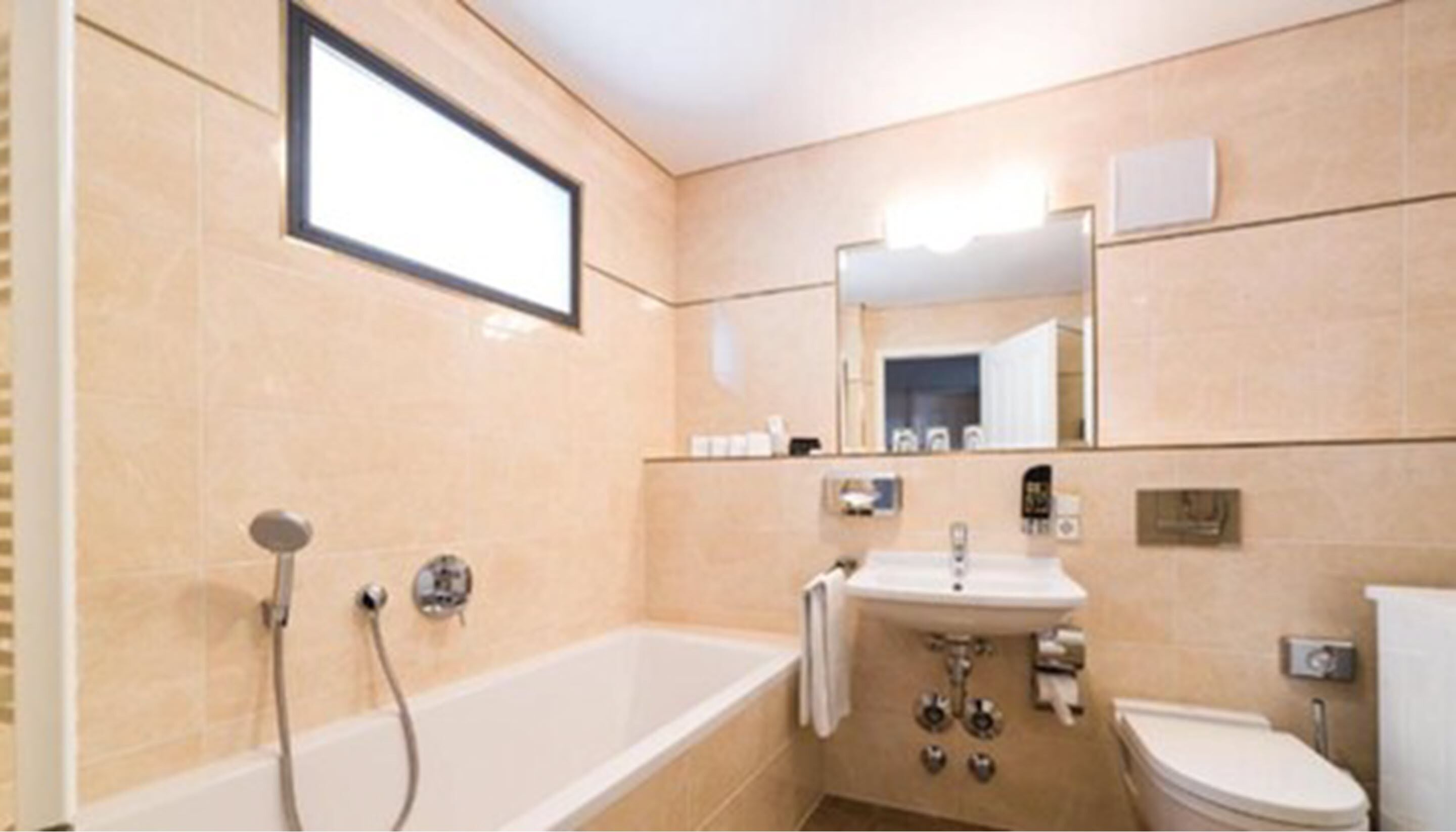 A bathroom with a bathtub, sink, and toilet.