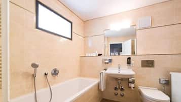 A bathroom with a bathtub, sink, and toilet.