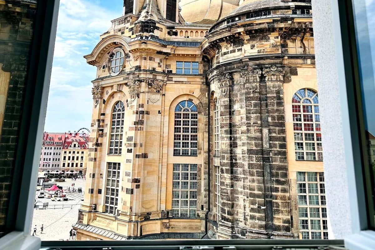 A historic building with ornate architecture, large windows, and a dome.
