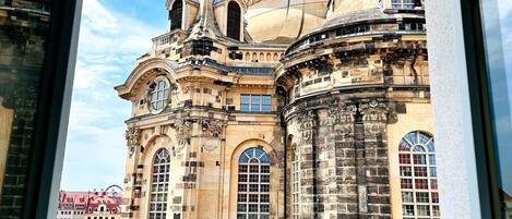 A historic building with ornate architecture, large windows, and a dome.
