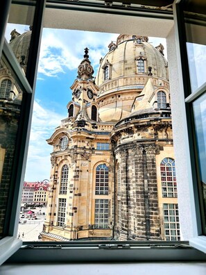 A historic building with ornate architecture, large windows, and a dome.