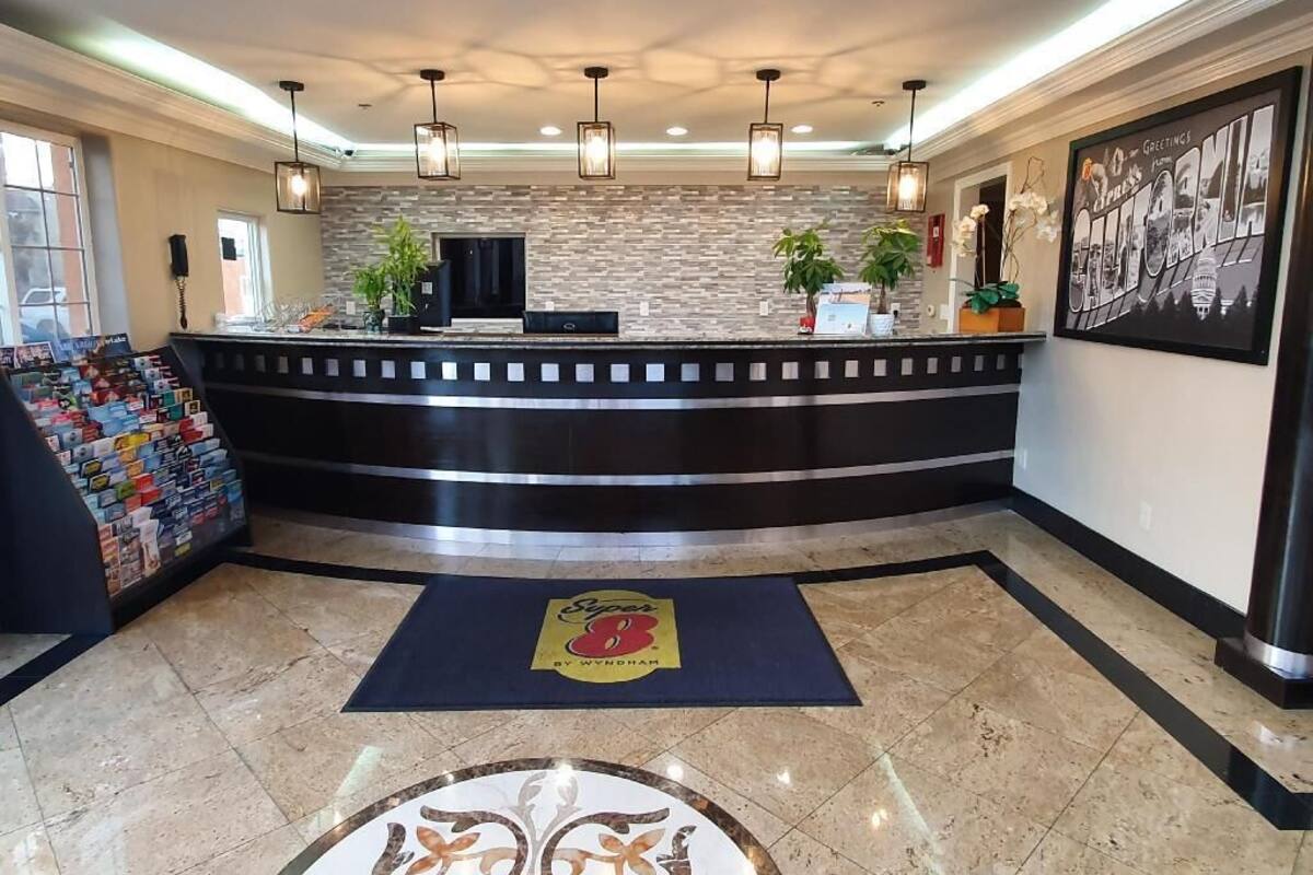 A reception area with a curved counter, a stone wall backdrop, and a reception desk.