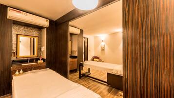 Relax in this stylish room with a large bed, bench, and modern vanity.