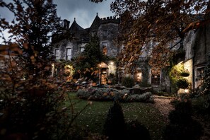 A historic stone building with multiple windows and a well-maintained garden. - The Close Hotel (Tetbury)