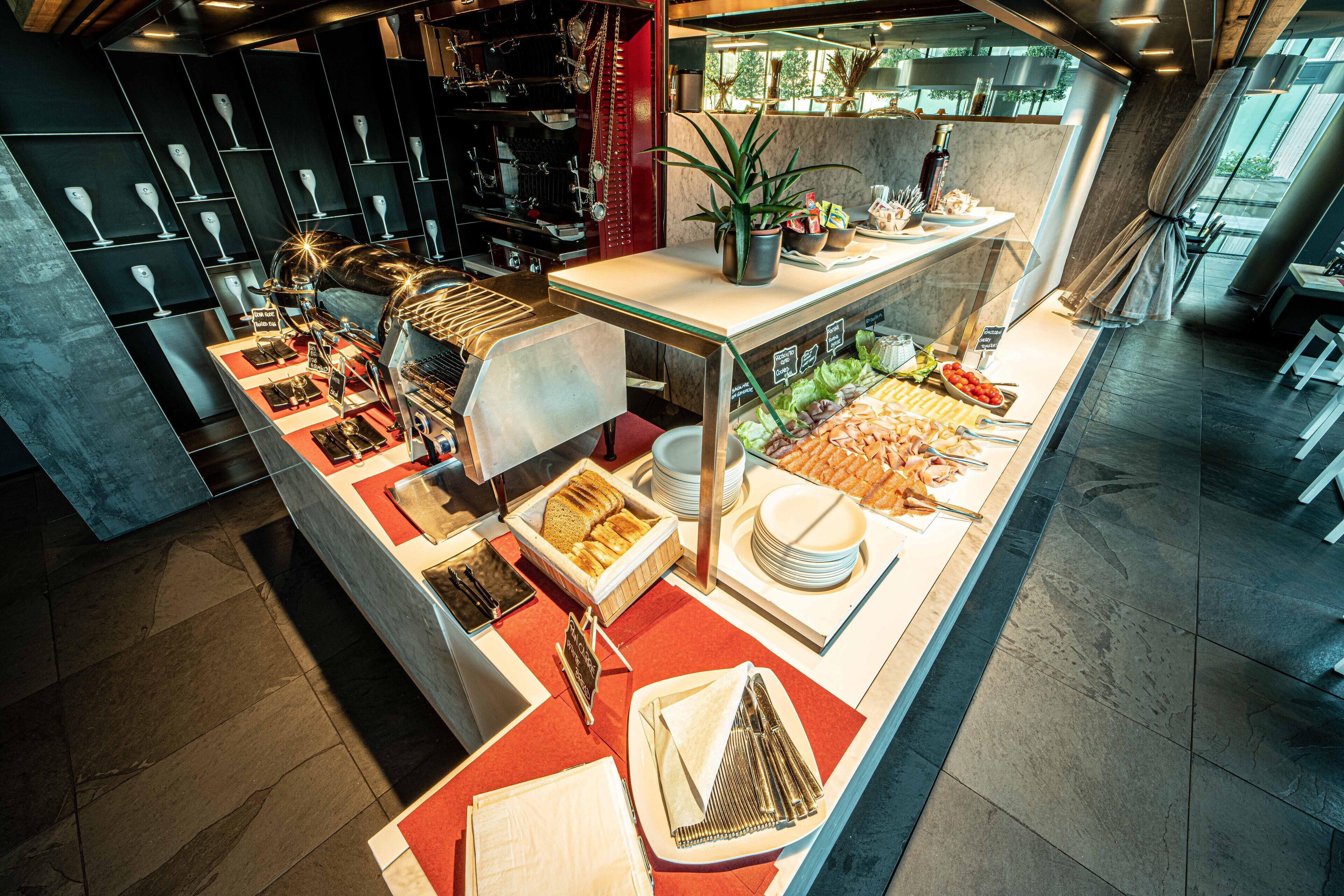 A buffet with various food items and utensils.