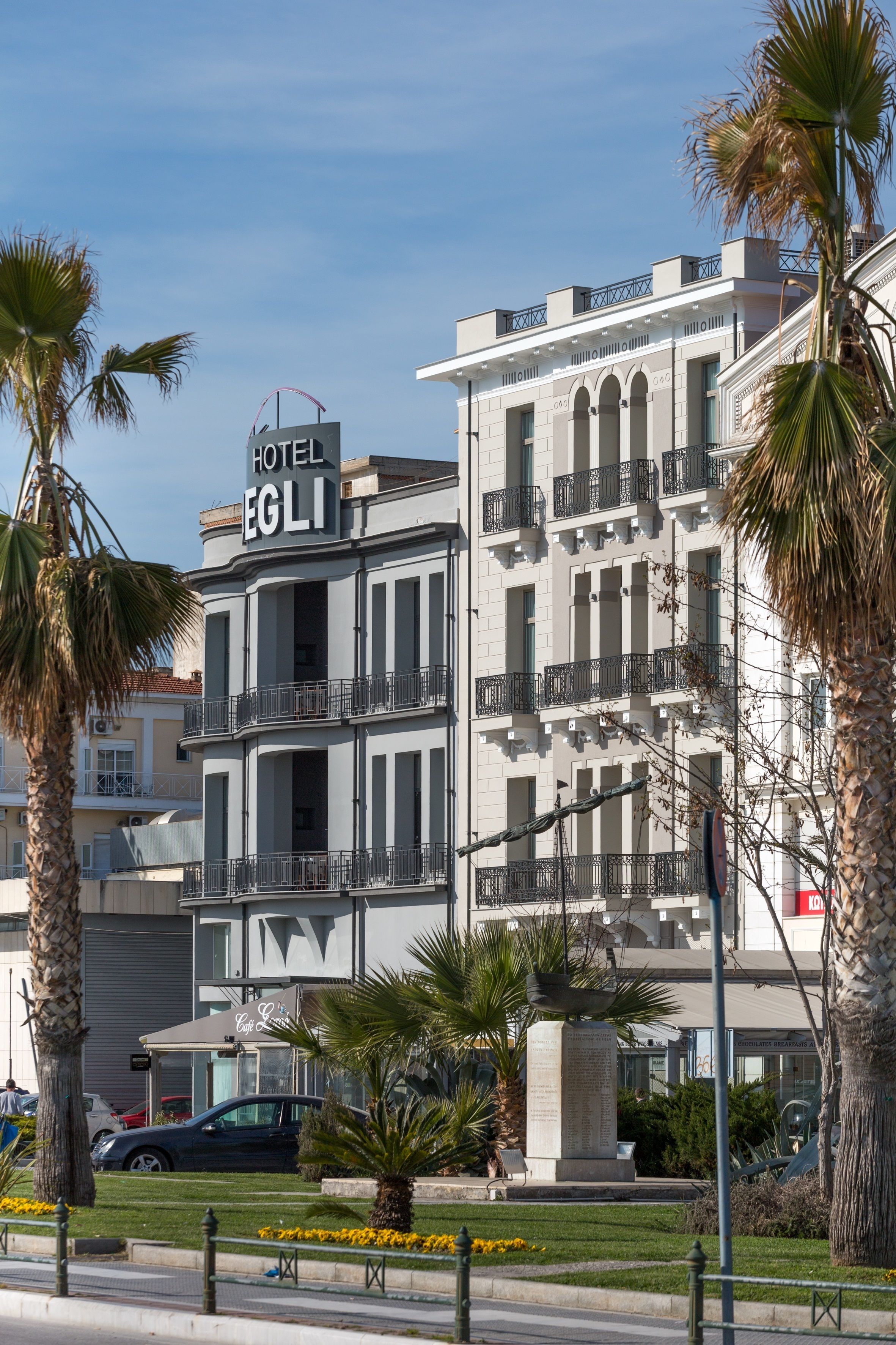 A multi-story hotel with balconies and a sign reading "HOTEL EGLI".