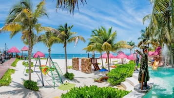 A beach resort with a pool, palm trees, and beach chairs.