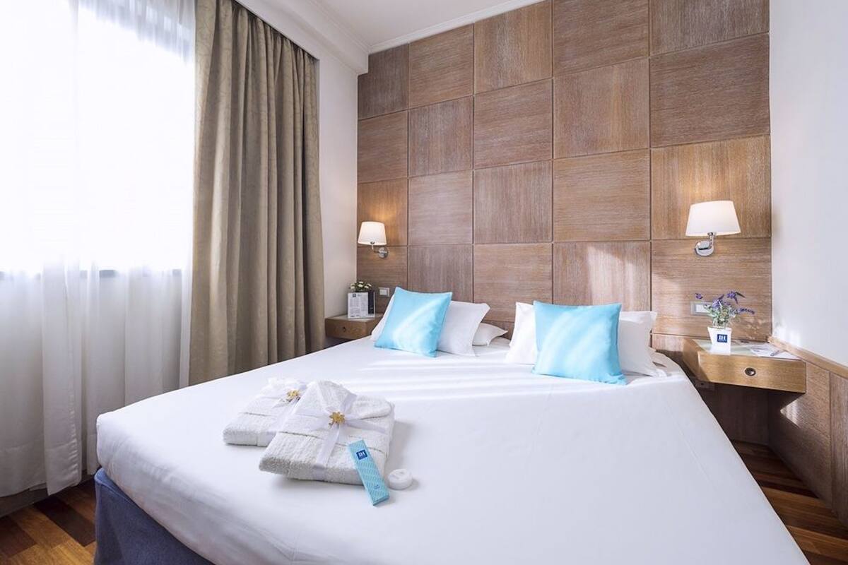 Standard Double Room | Minibar, in-room safe, desk, blackout drapes
