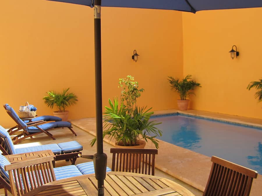 Una piscina al aire libre, sillones reclinables de piscina