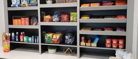 A well-organized pantry with various food items and snacks.