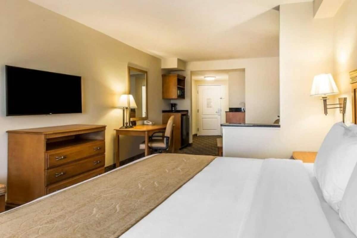 Premium bedding, desk, laptop workspace, blackout drapes
