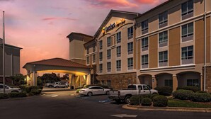 A hotel with a large sign reading "Comfort Suites." There are multiple parking spaces, including handicapped-accessible ones. - Comfort Suites Valdosta Mall Area (Valdosta)