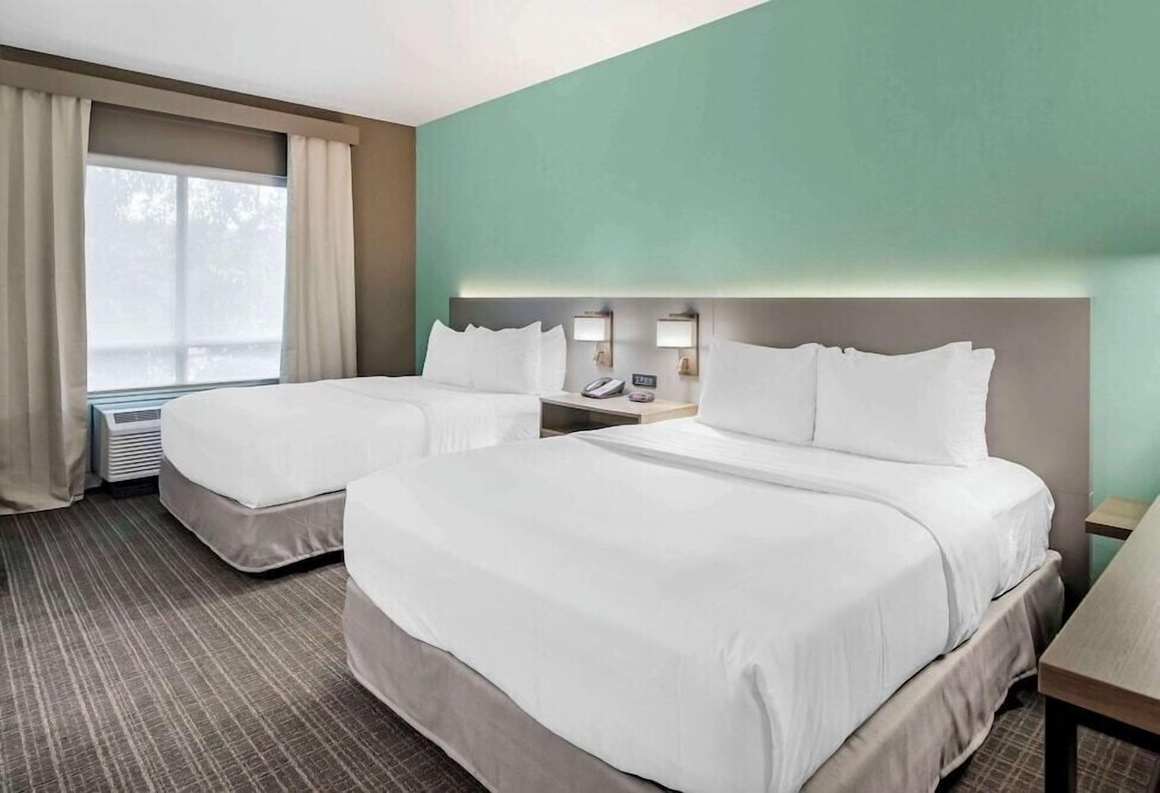 Premium bedding, desk, laptop workspace, blackout drapes