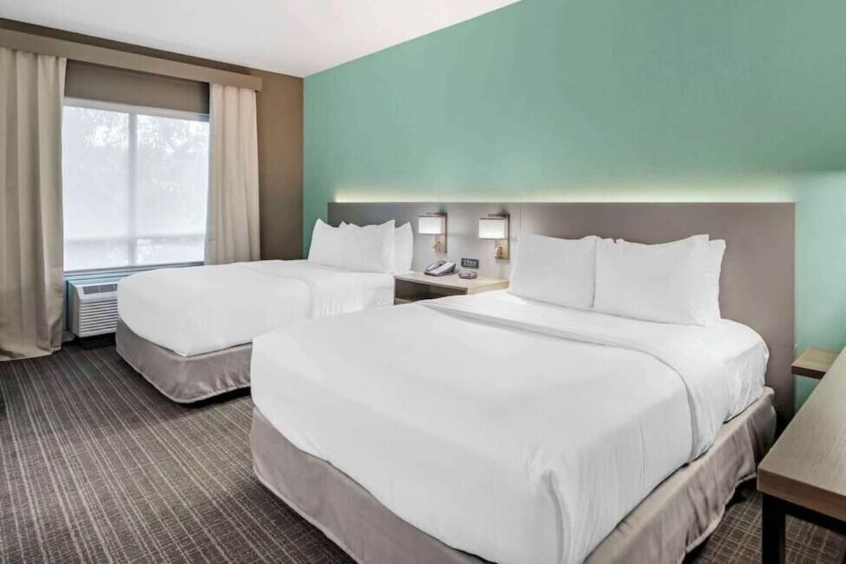 Premium bedding, desk, laptop workspace, blackout drapes