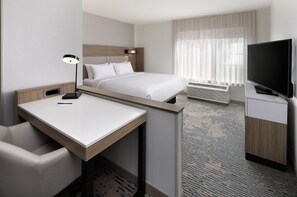 A hotel room with a bed, a desk, a chair, a television, and a window with curtains. - SpringHill Suites by Marriott Appleton (Appleton)