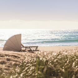 On the beach, white sand, sun loungers, beach umbrellas
