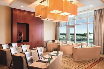 A modern hotel lobby with a bar area, seating, and a view of the outdoors. at The Ritz-Carlton Bal Harbour, Miami