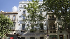 A historic building with a sign for 'Hotel Puerta de Banos'. - Petit Palace Puerta de Triana (Seville)