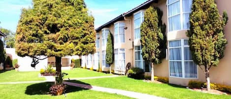 A row of modern, two-story buildings with large windows and a well-maintained lawn.