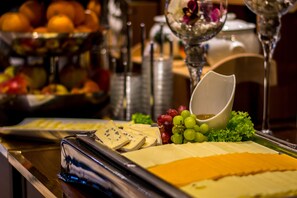 Enjoy a selection of cheeses and fresh fruits at our buffet.