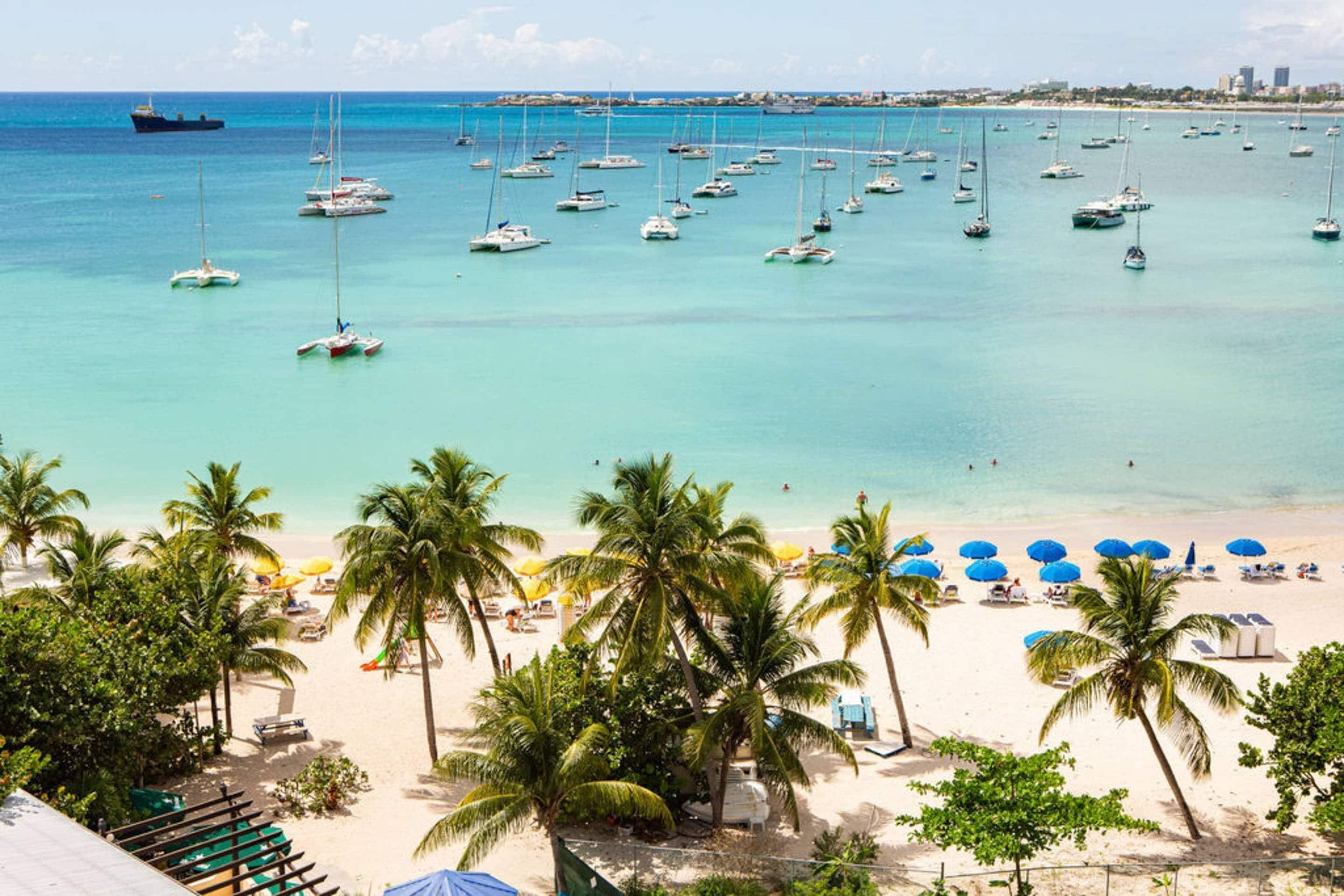 On the beach, white sand, sun loungers, beach umbrellas