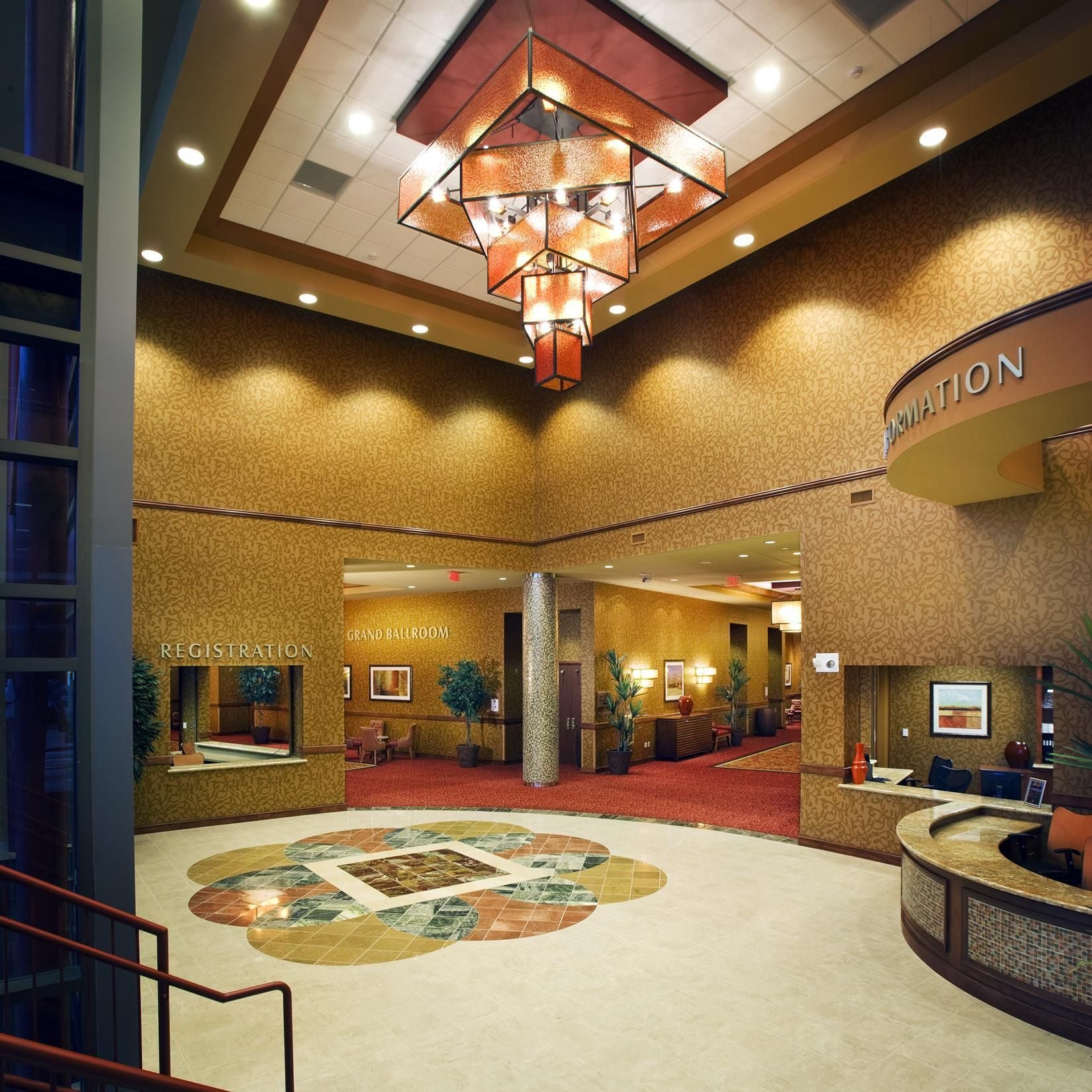 A hotel lobby with a registration desk, a grand ballroom, and a reception area.