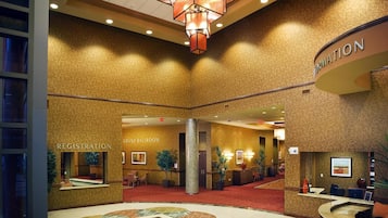 A hotel lobby with a registration desk, a grand ballroom, and a reception area.