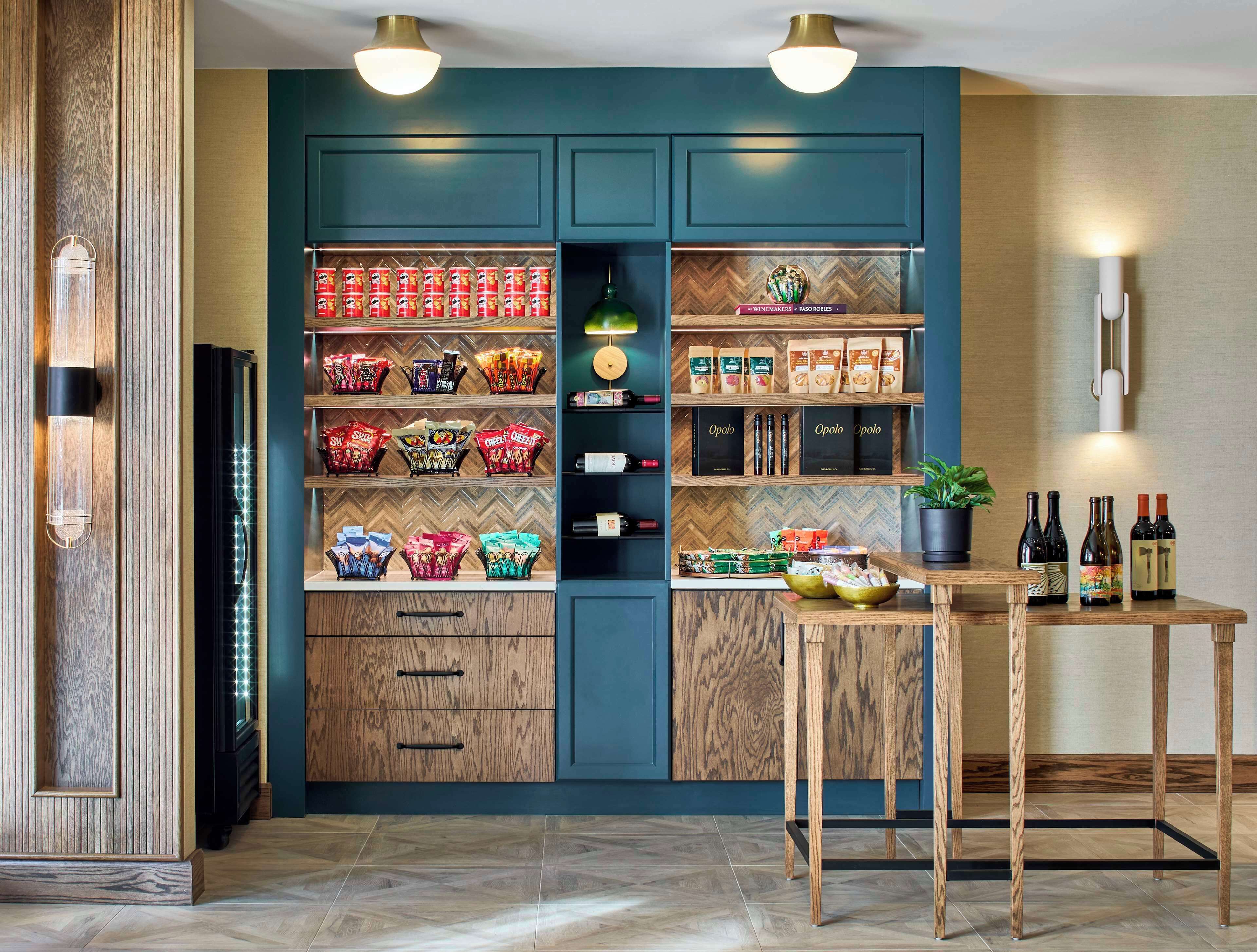 A modern kitchen with wooden cabinets, a built-in wine rack, and a dining table with chairs.