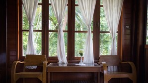 Wooden Villa | Living area | 21-inch TV with satellite channels, books - Baythani Samui Resort (Koh Samui)
