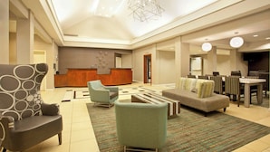 A spacious lobby with a reception desk, seating area, and a dining setup. - Residence Inn by Marriott Jackson Ridgeland (Ridgeland)