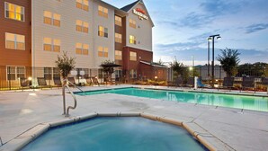 A hotel with a swimming pool, outdoor seating, and a Marriott Residence sign. - Residence Inn by Marriott Jackson Ridgeland (Ridgeland)