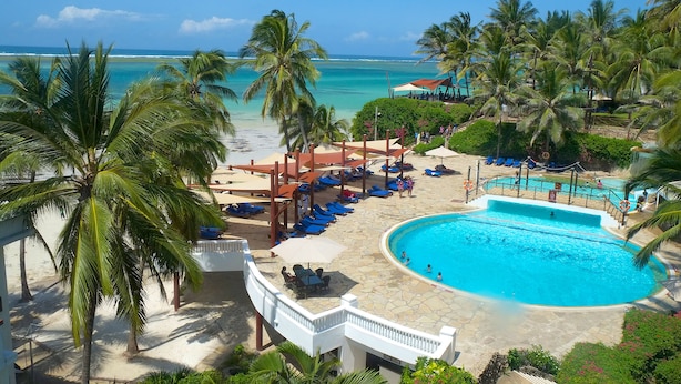 A resort with a swimming pool, beach, and palm trees. - Voyager Beach Resort (Mombasa)