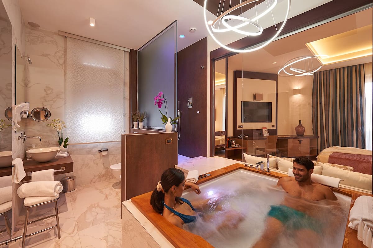 suite (jacuzzi) | bathroom | shower, rainfall showerhead, hair dryer, bathrobes
