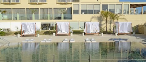 Outdoor pool, open 9:00 AM to 6:00 PM, pool umbrellas, pool loungers