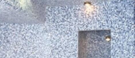 A spa area with a mosaic wall and a seating area.