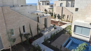 A modern residential complex with multiple buildings, a swimming pool, and a landscaped garden area. - E Hotel Spa & Resort Cyprus (Pervolia)