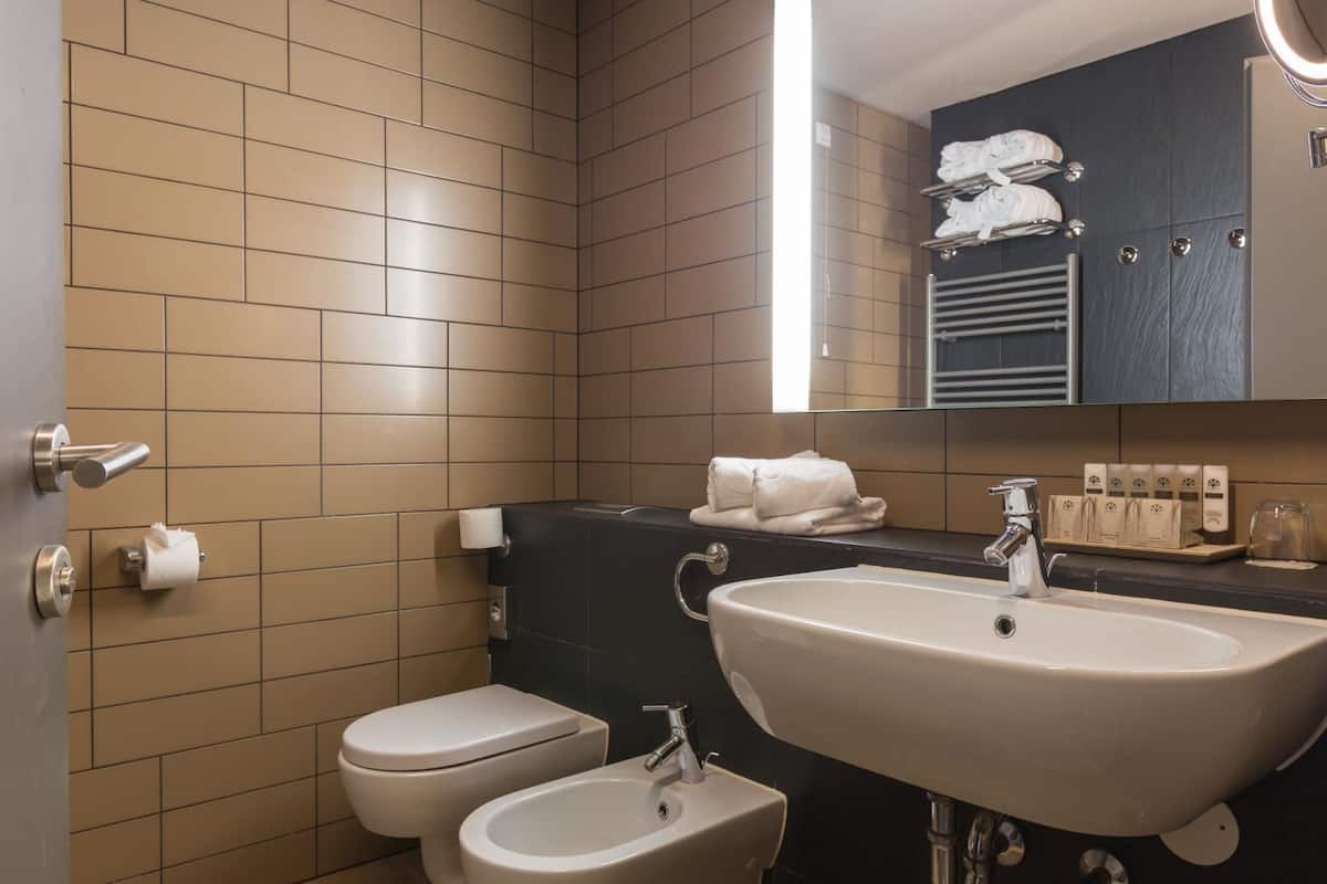 deep-soaking bathtub, bathrobes, slippers, towels