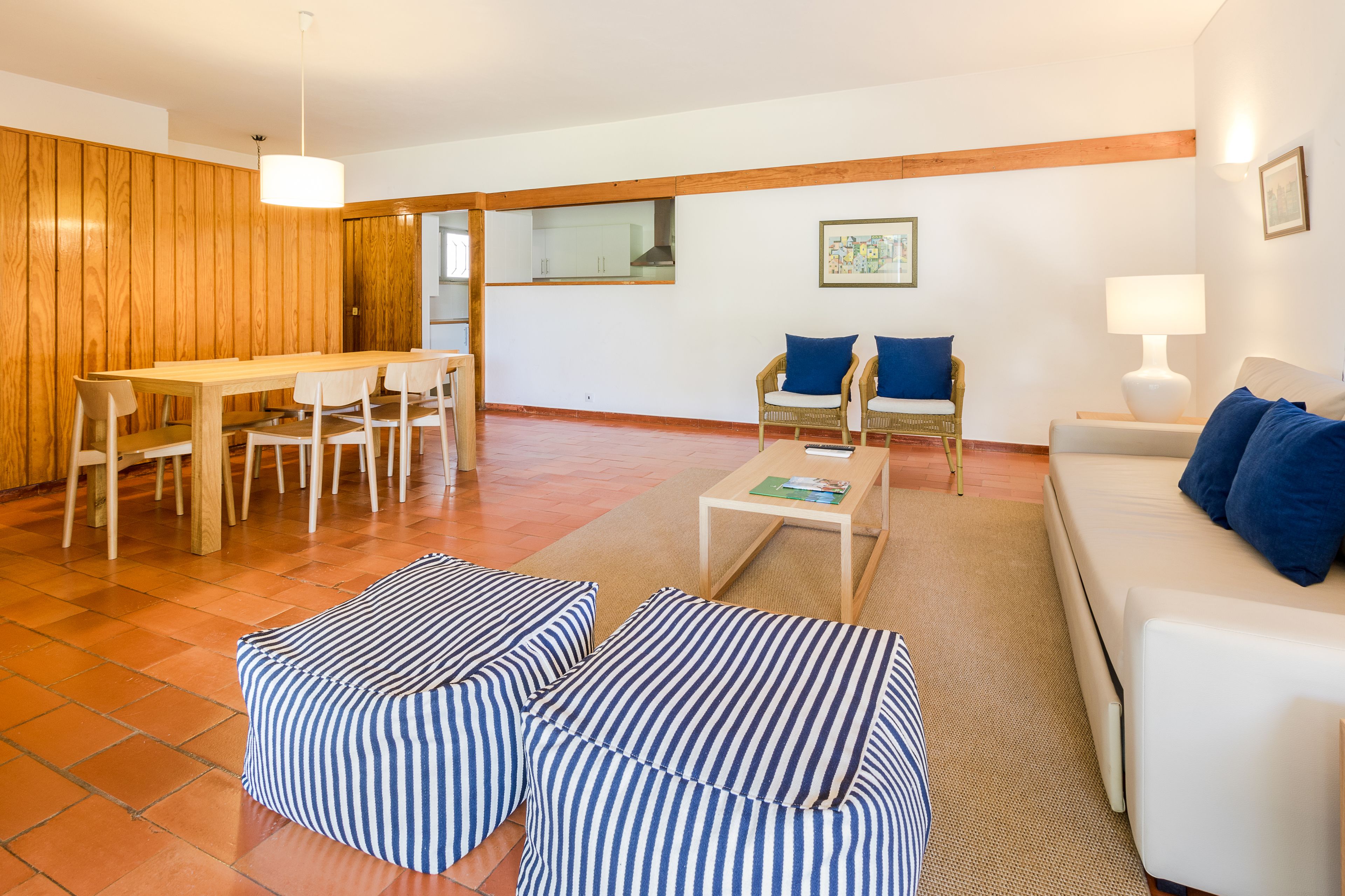 A modern living room with a dining area, a sofa set, and a coffee table.