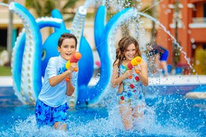 Children playing with water toys in a pool area with inflatable structures. - Barceló Maya Palace - All Inclusive (Xpu-Ha)