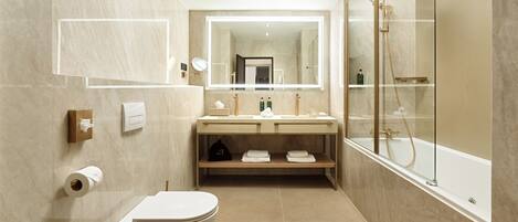 A modern bathroom with a toilet, sink, and shower.