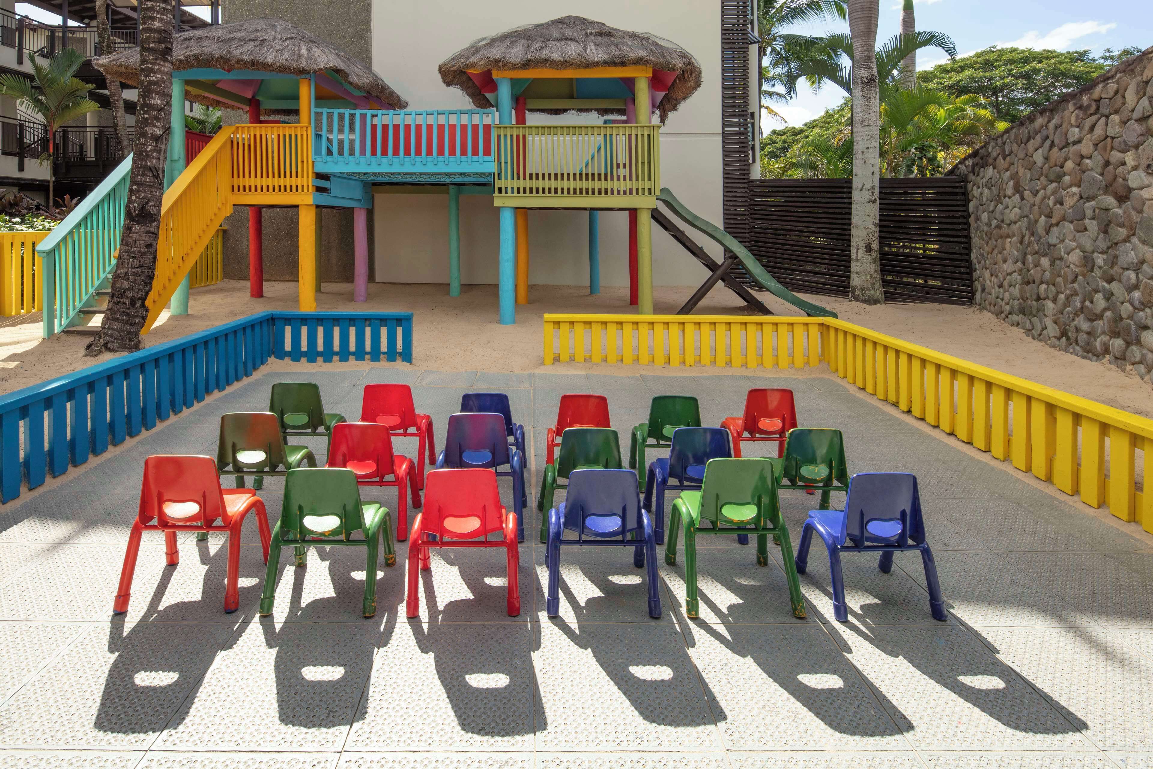 A children's play area with colorful structures and seating.
