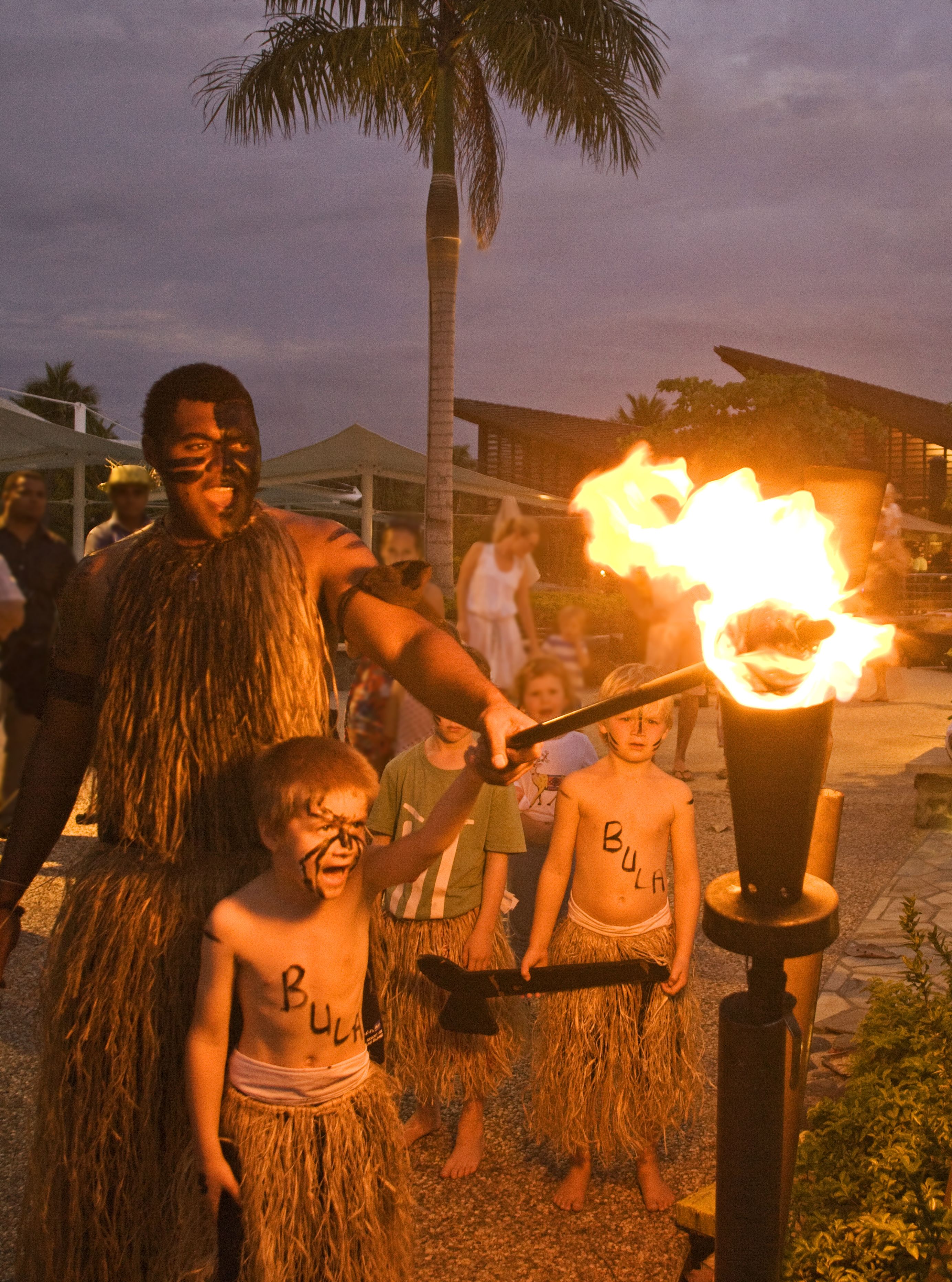 A person in a traditional costume with a torch.