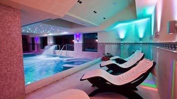 Relax by the pool surrounded by a soothing water feature and comfortable seating.