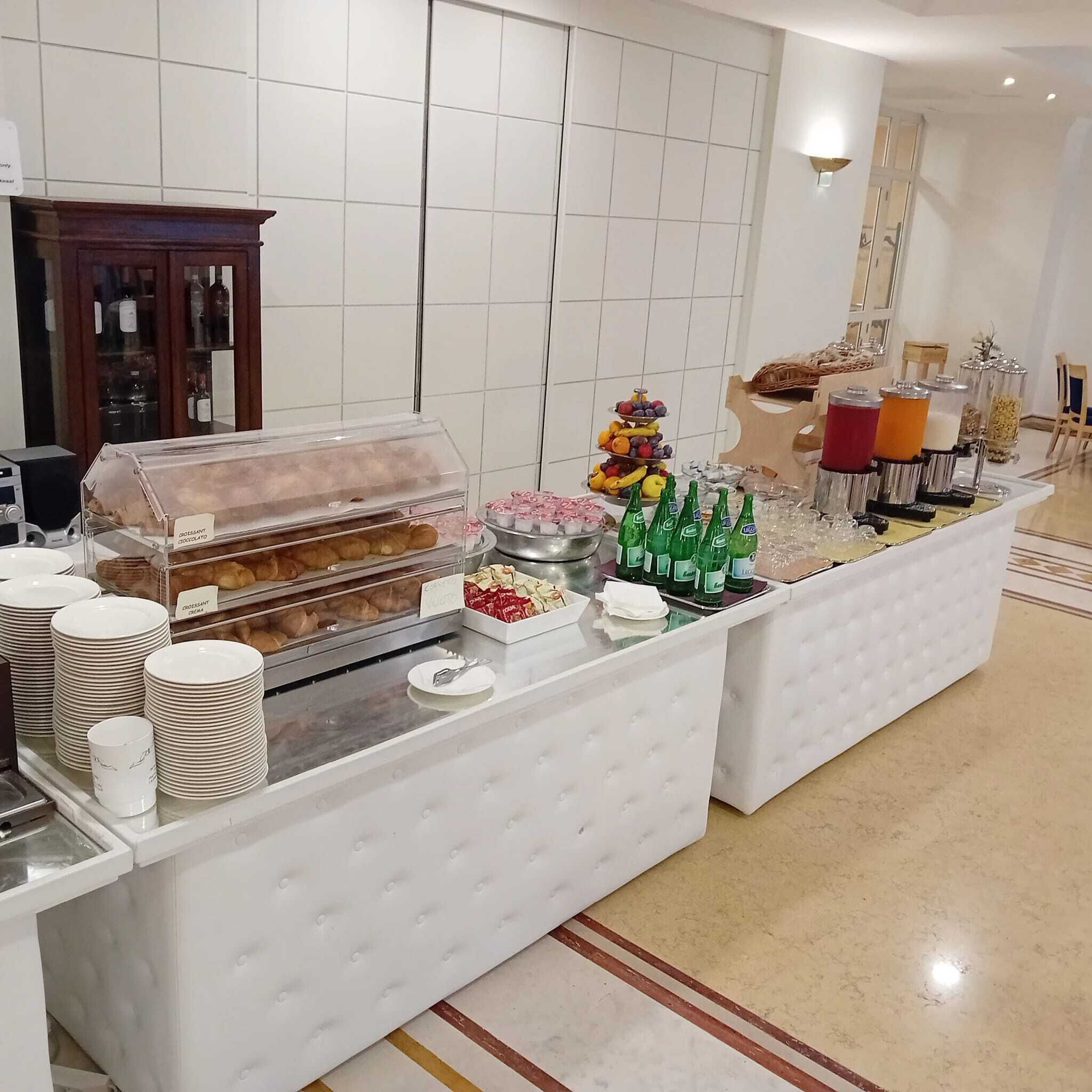 A buffet setup with various food items and beverages.
