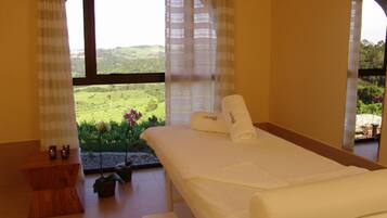 Relax in a serene bedroom with a lush landscape view, featuring a comfortable bed and stylish decor.