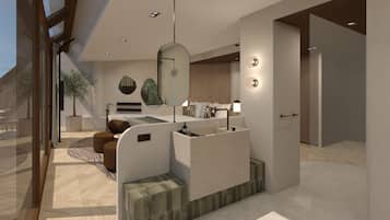 Relax in a serene space with a comfortable seating area, desk, and a large window offering a view.