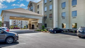 A hotel entrance with a covered driveway, multiple parking spaces, and a clear sky. - Comfort Inn & Suites North Little Rock McCain Mall (North Little Rock)