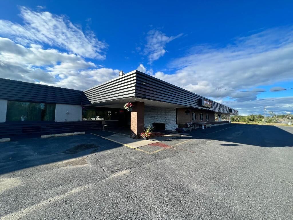 A building with a flat roof and a covered entrance area.