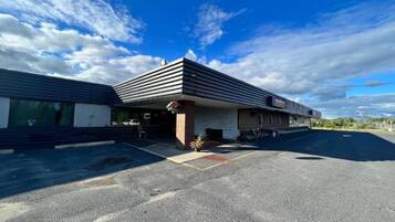 A building with a flat roof and a covered entrance area.