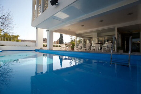 Outdoor pool, pool umbrellas, lifeguards on site